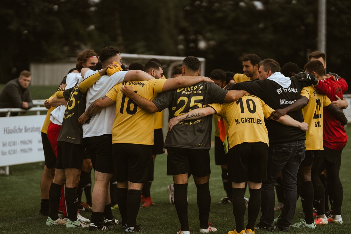 Sports team huddled together on the field