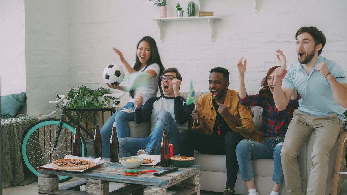Fans watching a match together at home